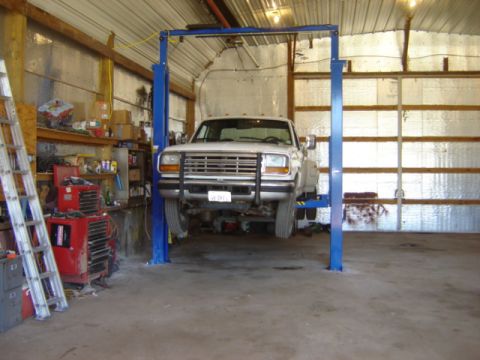 1992 Ford Bronco - Ford F-Series truck undergoing service on a lift in a workshop.