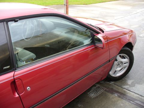 1991 Ford Probe - Side view of a red coupe, with 'PROBE' visible on the door panel.