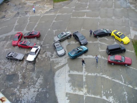 1991 Ford Probe - An aerial view shows a variety of vehicles arranged on a paved surface.