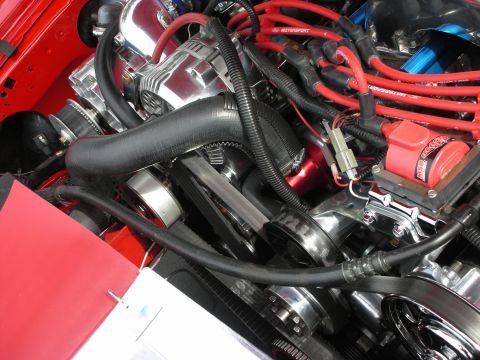 1992 Ford Crown Victoria - Close-up view of a modified engine bay with polished metal parts and vibrant red ignition wires.