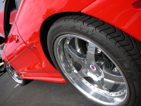1992 Ford Crown Victoria - Custom chrome wheel and tire detail on a red vehicle.
