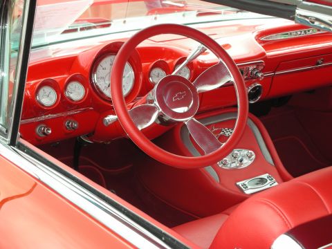 1992 Ford Crown Victoria - The vibrant red interior features a custom steering wheel and a dashboard filled with gauges.