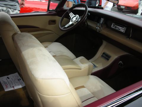 1992 Ford Crown Victoria - The interior of a custom car features plush tan seats and a retro-style dashboard with a modern radio.