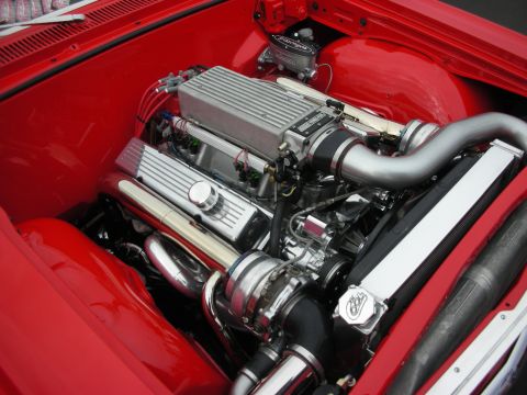 1992 Ford Crown Victoria - Close-up view of a modified V8 engine with a supercharger and custom exhaust components.