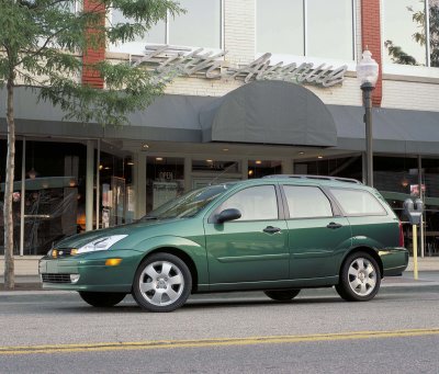 2002 Ford Focus - Green 2002 Ford Focus wagon seen from the side parked in front of a building.