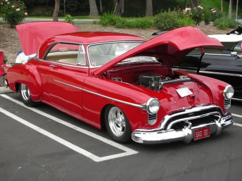 1992 Ford Crown Victoria - This classic red coupe has its hood and trunk open, revealing the engine bay.