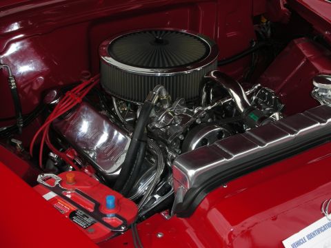 1992 Ford Crown Victoria - The engine bay features a polished V8 engine with a prominent air filter and red spark plug wires.