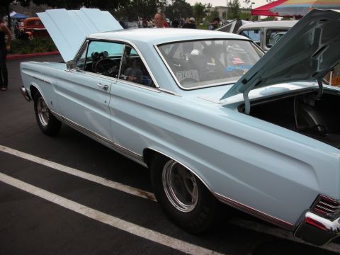 1992 Ford Crown Victoria - Light blue classic coupe at a car show, hoods open, revealing the engine bay and trunk space.