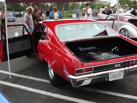 1992 Ford Crown Victoria - A red 1969 Chevrolet Nova SS is displayed with its trunk open, revealing racing modifications.