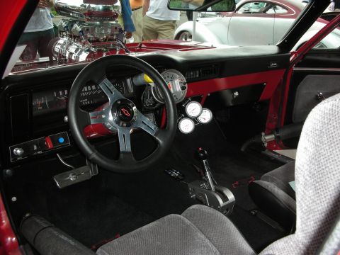 1992 Ford Crown Victoria - The interior of a modified car features a prominent engine and racing-style controls, with another vehicle in the background.