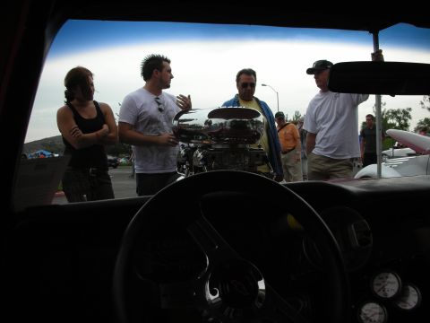 1992 Ford Crown Victoria - People admire a custom chrome engine at a car show, viewed from the driver's seat.