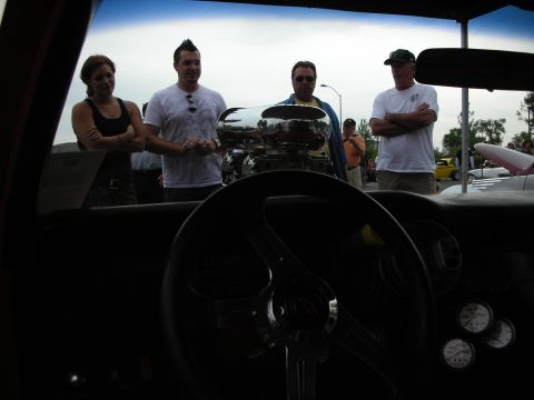 1992 Ford Crown Victoria - View from inside a car shows a prominent chrome engine blower and onlookers at a car show.