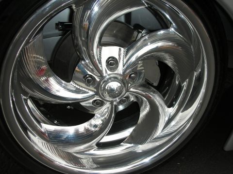 1992 Ford Crown Victoria - A highly polished custom wheel with intricate detailing is shown up close.