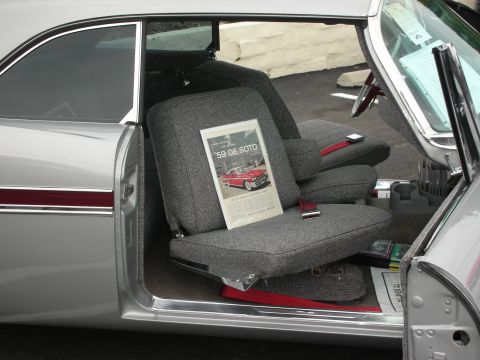 1992 Ford Crown Victoria - A vintage advertisement for a '59 De Soto is placed on the grey patterned seats of a classic silver car.
