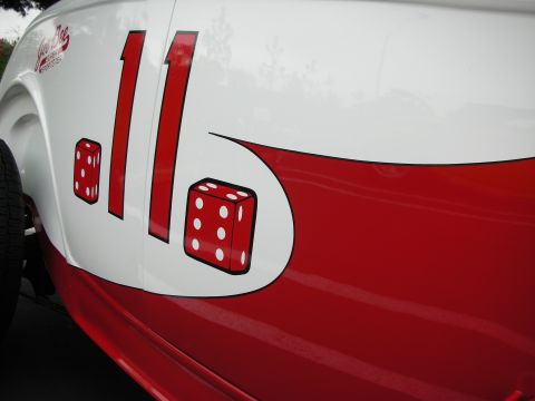 1992 Ford Crown Victoria - Side view of a white and red race car the number 11 and dice graphics, suggesting a custom paint job or racing livery.