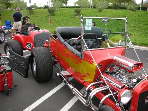 1992 Ford Crown Victoria - A custom hot rod with a skeleton driver and flame paint job is parked outdoors.