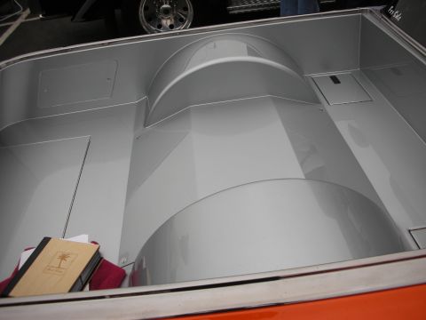 1992 Ford Crown Victoria - The interior of a truck bed is shown, with a notebook and red cloth placed inside. Another vehicle's wheel is visible in the background.