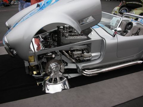 1992 Ford Crown Victoria - Silver convertible with exposed engine and blue flames on hood, "COBRA 427" engine cover visible.