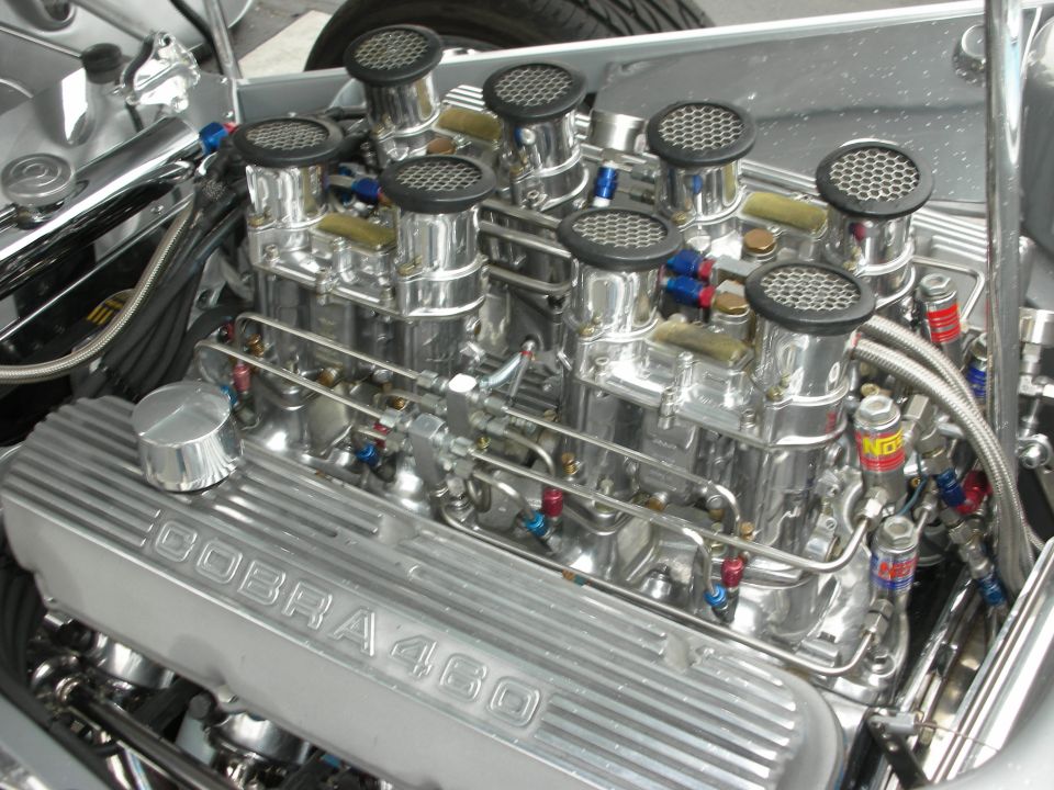 Close-up of a Cobra 460 engine with multiple carburetors and chrome valve covers