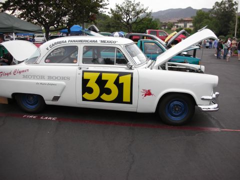1992 Ford Crown Victoria - A white race car with large yellow number 331 on its side is parked at a car show.