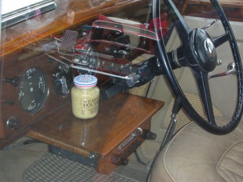 1992 Ford Crown Victoria - A jar of Grey Poupon sits on the dashboard of a vintage car, next to the steering wheel and gauges.