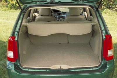 2002 Ford Focus - The rear cargo area and interior of a green wagon are visible with the trunk open.