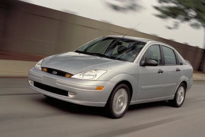 2002 Ford Focus - Silver 2002 Ford Focus sedan captured in motion on a paved road.