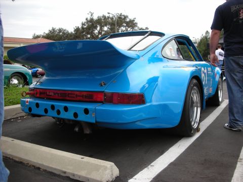 1992 Ford Crown Victoria - Rear view of a blue Porsche 911 race car parked at an event. A second car is visible in the background.