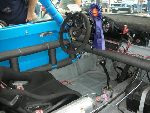 1992 Ford Crown Victoria - Interior view of a modified car with racing bucket seat and roll cage.
