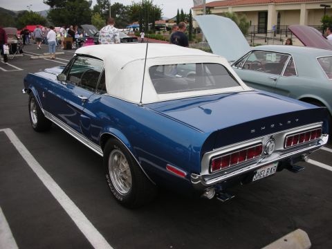 1992 Ford Crown Victoria - A blue Shelby Mustang convertible is parked at a car show with other vehicles present.
