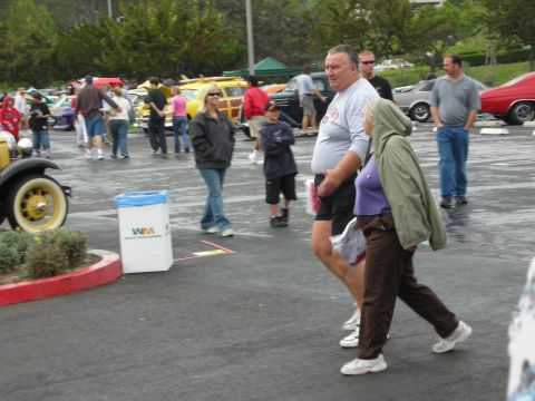 1992 Ford Crown Victoria - Attendees stroll through an outdoor event with multiple cars visible in the background.