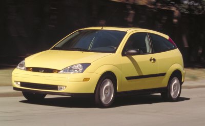 2002 Ford Focus - A yellow 2000 Ford Focus hatchback is shown from the front three-quarter angle.