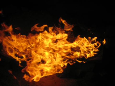 1990 Ford Bronco - long horizontal sheet of orange and yellow campfire flames swirling against darkness.