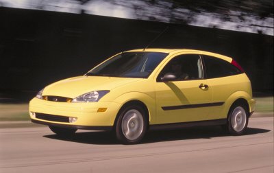 2002 Ford Focus - This yellow 2002 Ford Focus hatchback is shown from a three-quarter front view while driving.