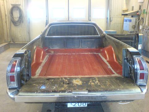 1972 Ford Ranchero - Rear view of a 1972 Ford Ranchero with a red-lined bed and chrome bumper.