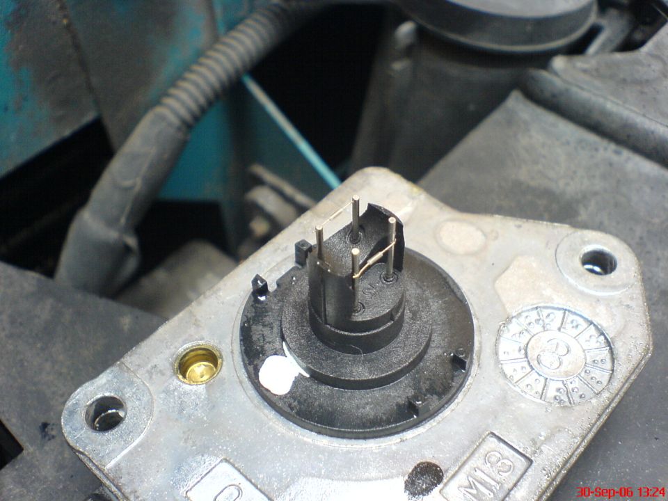 Close-up of a MAF sensor with cover removed showing internal sensing wires and pins