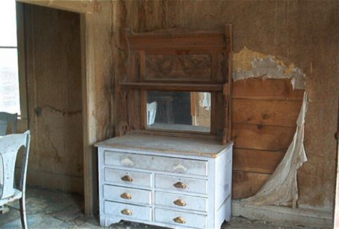 1986 Ford Bronco - Interior scene of a room with an antique dresser and mirror.