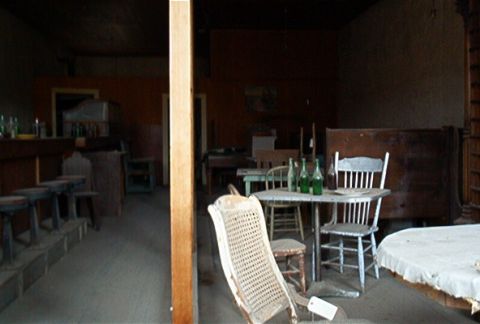 1986 Ford Bronco - This scene depicts the interior of a room with various furniture and bottles, not a 1986 Ford Bronco.