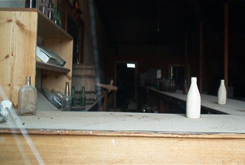 1986 Ford Bronco - View from behind a counter in a dusty, old bar setting with bottles on shelves and the bar top.