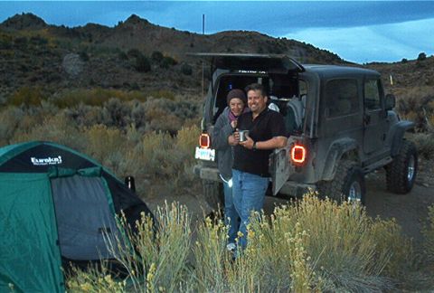 1986 Ford Bronco - Camp setup with a Jeep Wrangler and a tent in a dry, hilly landscape.