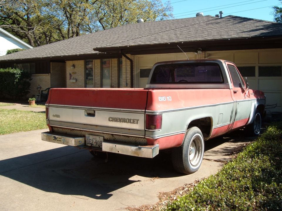 Rear view of a red and gray Chevrolet C10 pickup truck, circa 1980