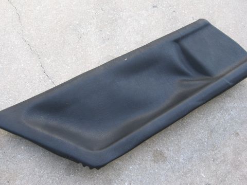 1974 Ford F-100 - This is a black plastic trim piece, likely an interior component, shown on a concrete surface.