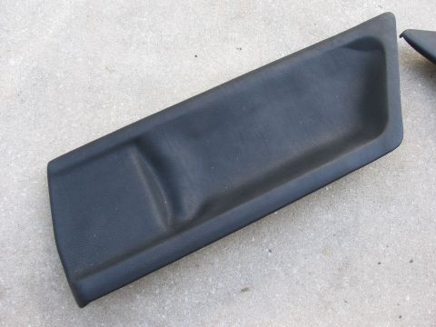 1974 Ford F-100 - A black plastic interior trim piece is shown against a concrete surface. The piece has a shallow, rectangular indentation.
