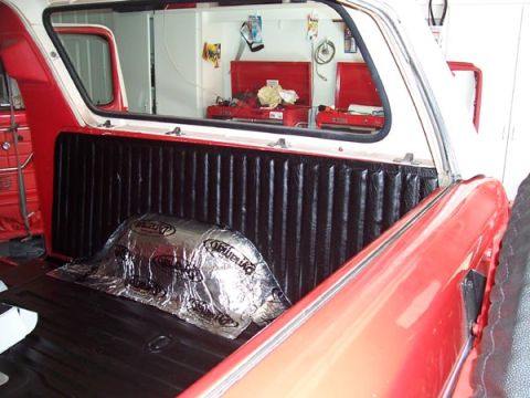 1978 Ford Bronco - The interior of a 1978 Ford Bronco features sound dampening material on the rear wheel well and red body panels.