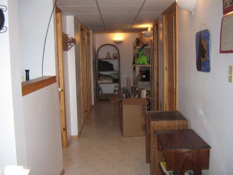 1995 Ford Bronco - A view down a hallway with various storage items and unfinished doorways.