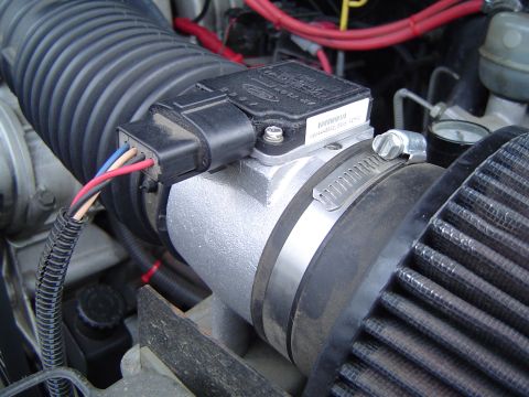 1989 Ford Bronco - Close-up of a Ford mass air flow sensor, part of the vehicle's air intake system.