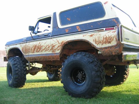 1992 Ford Mustang - This lifted 1978 Ford Bronco is heavily covered in mud, showing its off-road capabilities.
