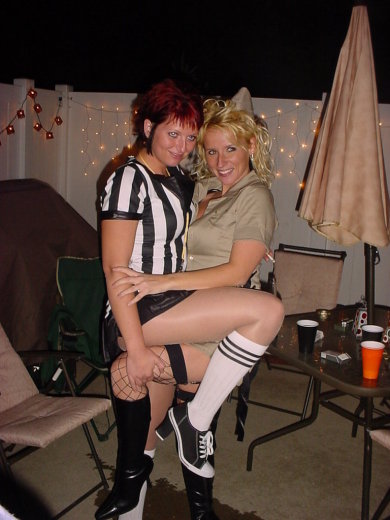 1995 Ford Probe - Two women in costumes pose for a photo during an outdoor gathering at night.