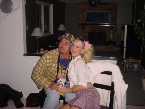 1995 Ford Probe - A couple poses for a photo indoors, with the man wearing a plaid shirt and the woman in a pink plaid skirt.