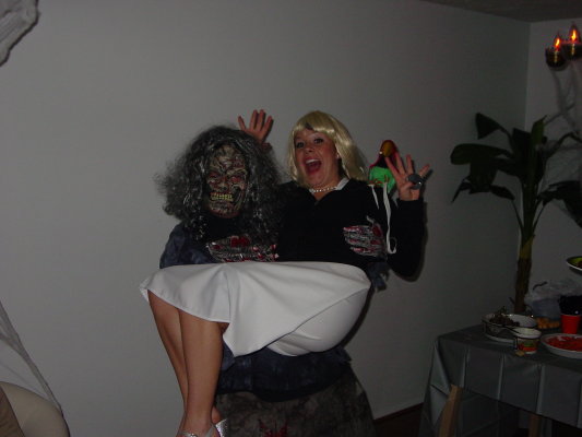 People in Halloween costumes, one dressed as a zombie, the other as a blonde woman